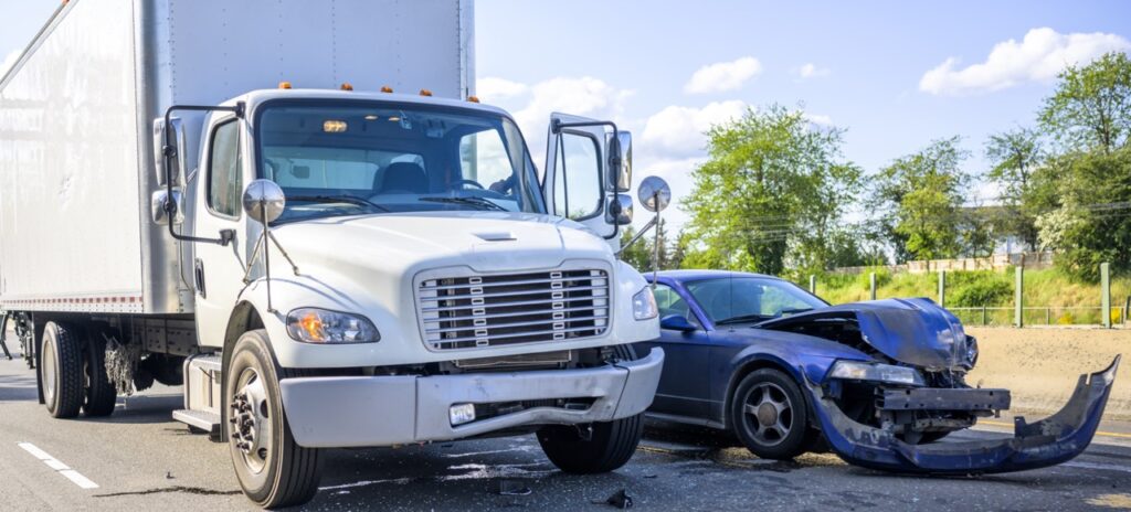 Collision between a semi truck with trailer and a car