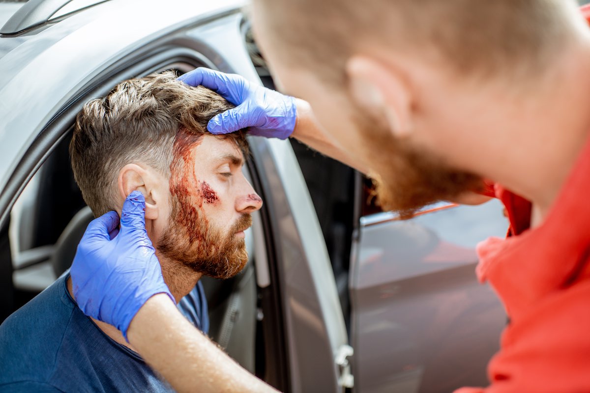 Medic examining victim after a car accident