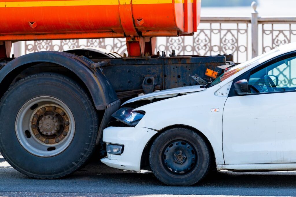 Orange truck and a white collison