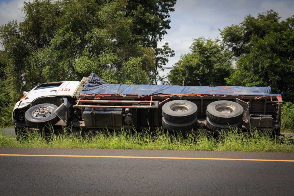 Overturned flatbed truck accident on the road