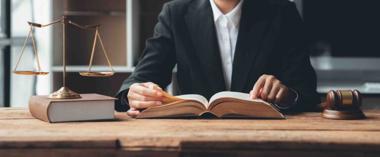 A lawyer reading a legal book about the legal rights of undocumented immigrants in the U.S.