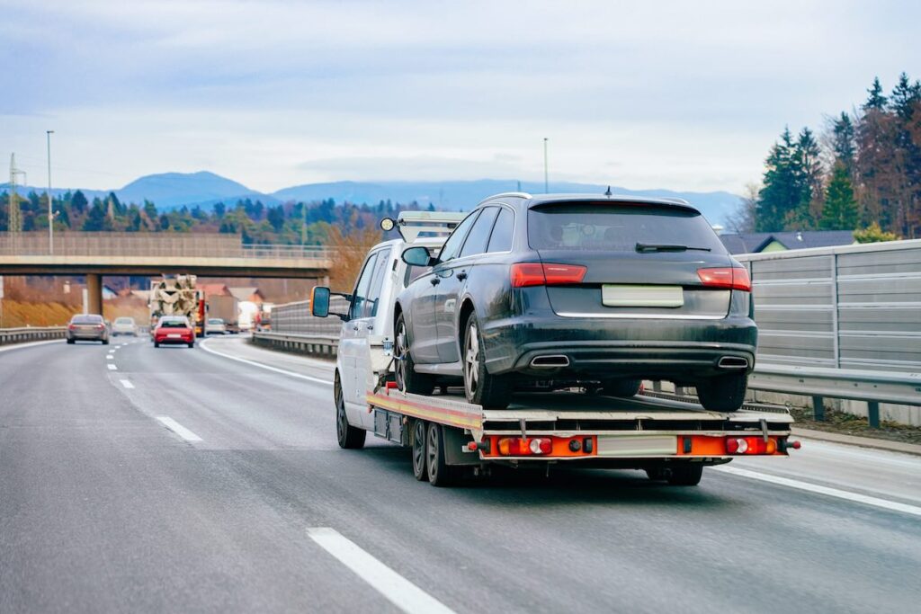 Tow truck and crashed car on the road