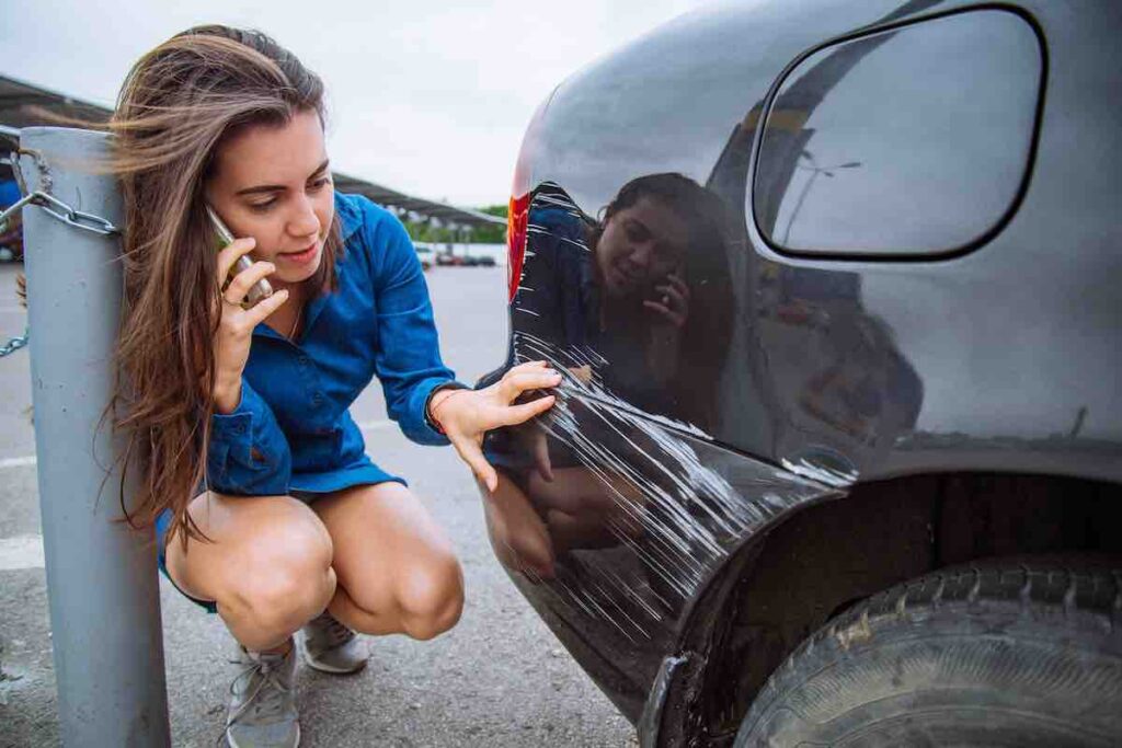 A woman calling for help after a car accident on the road