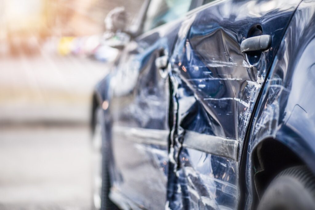 Damage side door after a car crash on highway