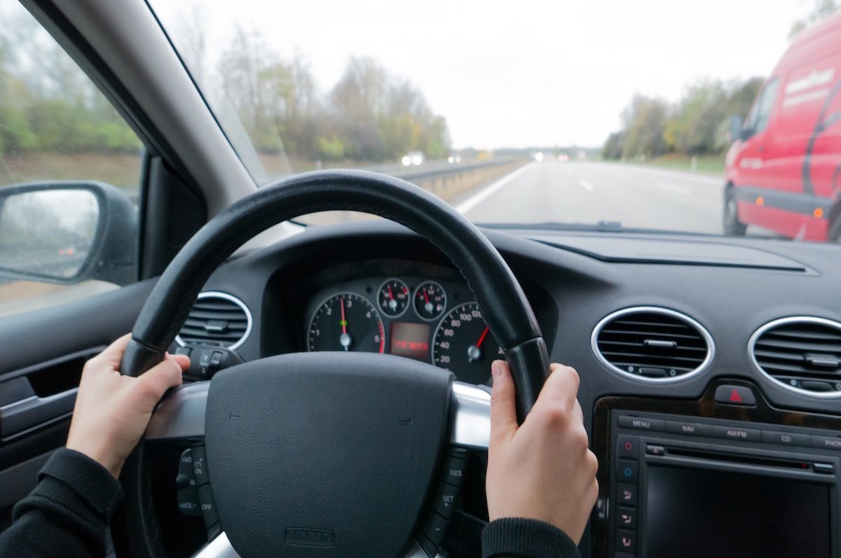 Young woman overtaking other car on highway