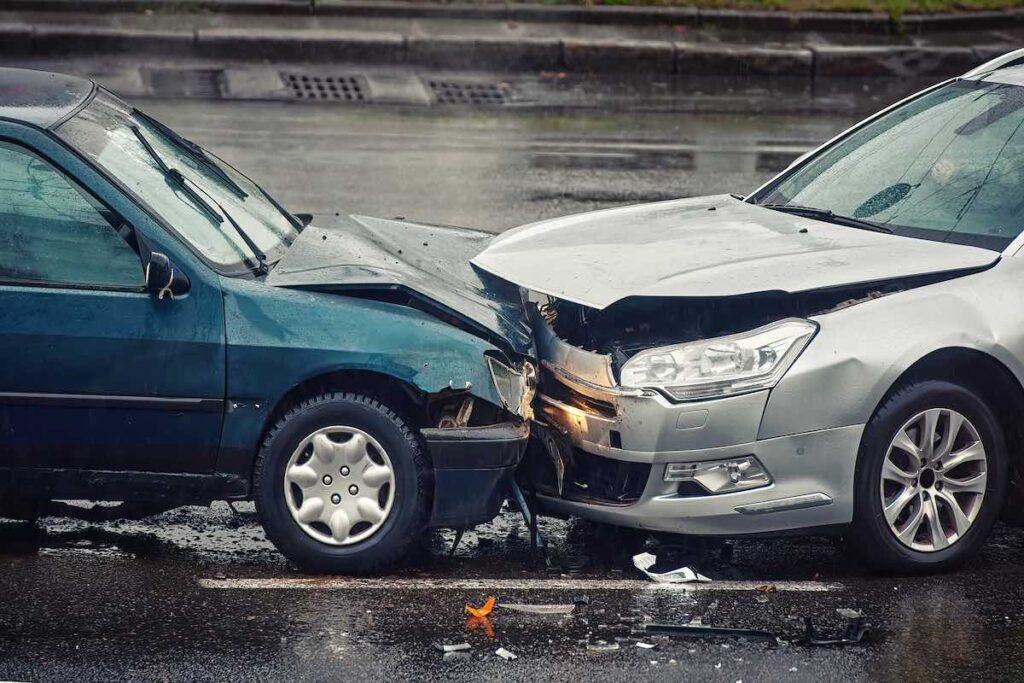 head on collision side view on wet road during rain