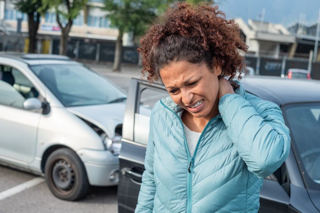 Woman thinking of going to a chiropractor after suffering whiplash from an accident