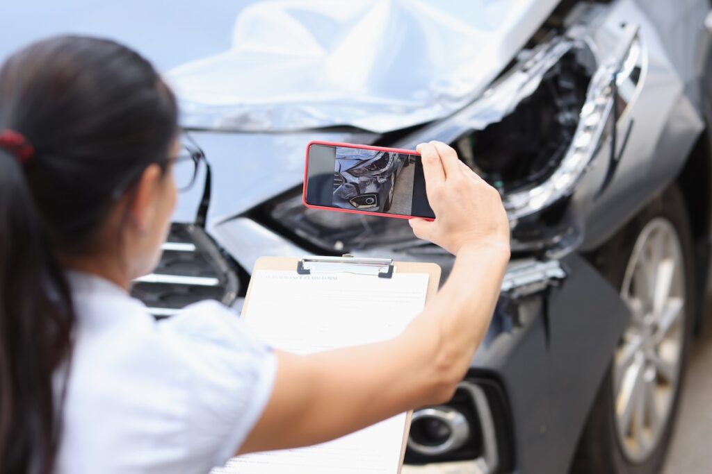 CSAA insurance agent takes pictures of damages to car after an accident