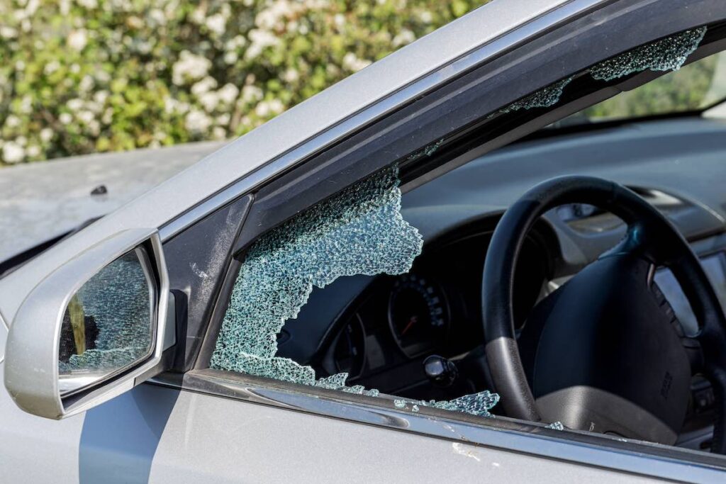 Broken driver's side window of car due to a possible robbery and assault in Ohio