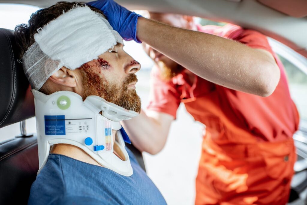 Medic applying bandage on the head of victim after a road accident in Pennsylvania