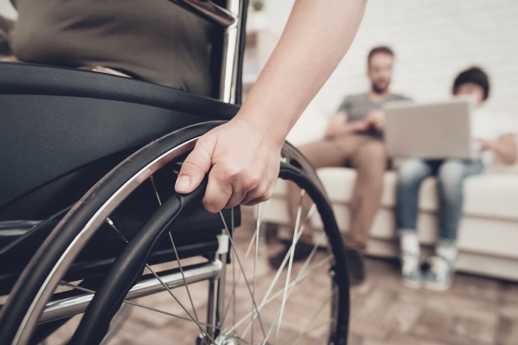 Disabled man in a wheelchair with the family researching about personal injury in Washington